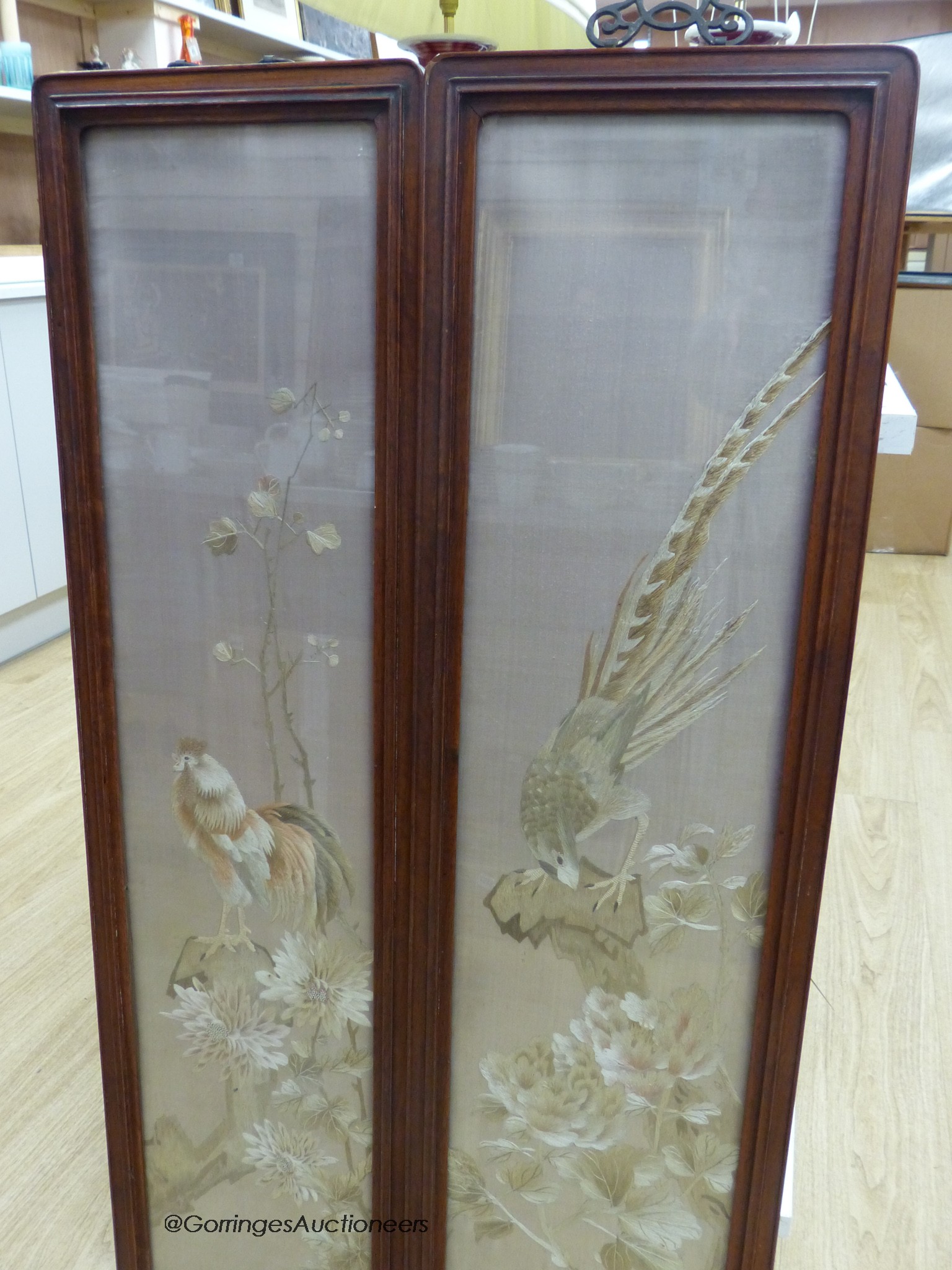 A pair of late 19th century Chinese embroidered silk pictures, in hongmu frames, 111 cm x 29 cm in total